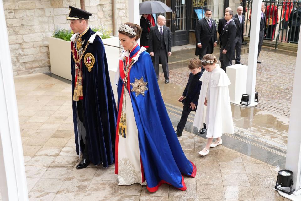 Prince William, Kate Middleton, Prince Louis, and Princess Charlotte process into King Charles III's coronation.