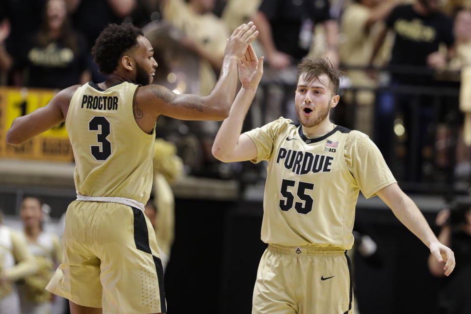 Purdue guards Sasha Stefanovic (55) and Jahaad Proctor (3) celebrate during the second half of the team's NCAA college basketball game against Virginia in West Lafayette, Ind., Wednesday, Dec. 4, 2019. Purdue won 69-40. (AP Photo/Michael Conroy)