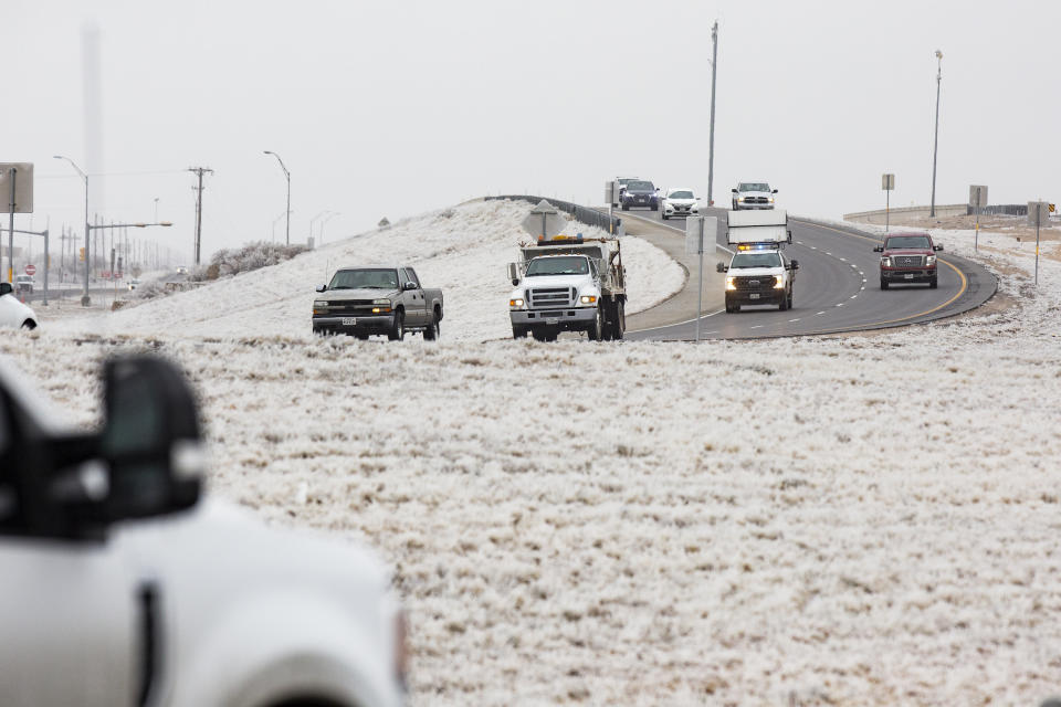 Motorist drive east on Texas State Highway 191 headed towards Midland from Odessa Friday, Feb. 12, 2021, in Midland County, Texas. Friday is the second day the Permian Basin has seen freezing weather as a Winter Weather Advisory issued by the National Weather Service for the region remains in effect until 11 a.m. Saturday. The NWS forecasts that the cold temperatures will remain in the Basin throughout the weekend with Sunday night seeing a 70% chance of snow. (AP Photo|Odessa American, Jacob Ford)/Odessa American via AP)