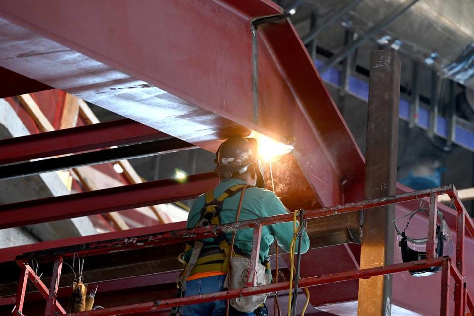 A welder works in the interior of the atrium of Mote SEA during a media tour of the ongoing construction on Friday, April 5, 2024.