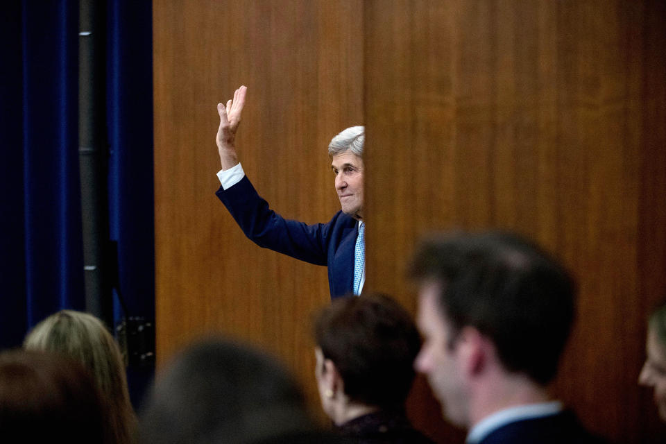 John Kerry waves at the State Department in Washington