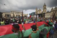 Indigenous protest against the government in Bogota, Colombia, Monday, Oct. 19, 2020. The leaders of the indigenous communities say they are mobilizing to reject massacres, assassinations of social leaders, criminalization of social protest, to defend their territory, democracy and peace, and plan to stay in the capital for a nationwide protest and strike on Oct. 21. (AP Photo/Fernando Vergara)