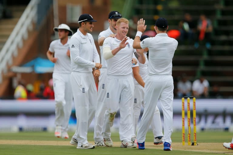 England's Ben Stokes (centre) celebrates after taking the wicket of South African batsman Stiaan Van Zyn on the opening day of the third Test in Johannesburg on January 14, 2016