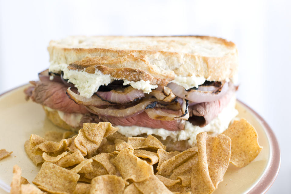 In this Feb. 6, 2012 image taken in Concord, N.H., a sandwich made of flank steak with slices of red onion marinated in Guinness lager and Boursin cheese, is shown. (AP Photo/Matthew Mead)