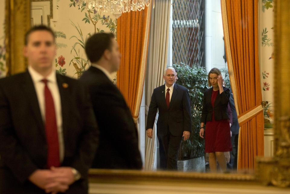 United States Vice President Mike Pence, center left, and European Union High Representative Federica Mogherini, right, are reflected in a mirror as they enter the room prior to a meeting at US ambassadors residence in Brussels on Monday, Feb. 20, 2017. U.S. Vice President Pence is currently on a two-day visit to meet with EU and NATO officials. (AP Photo/Virginia Mayo, Pool)