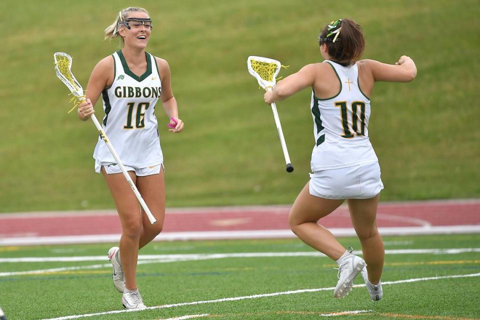Cardinal Gibbons’ Charlotte Jackson (10) celebrates with Izzi Hammond (16) after her goal during the first half. The Charlotte Catholic Cougars and the Cardinal Gibbons Crusaders met in the NCHSAA 4A Girls Lacrosse Final in Durham , NC on May 19, 2023.