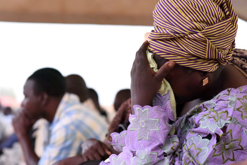 FILE PHOTO: Family members of victims of an ambush on workers near a Canadian-owned mine, react during their meeting with officials in Ouagadougou