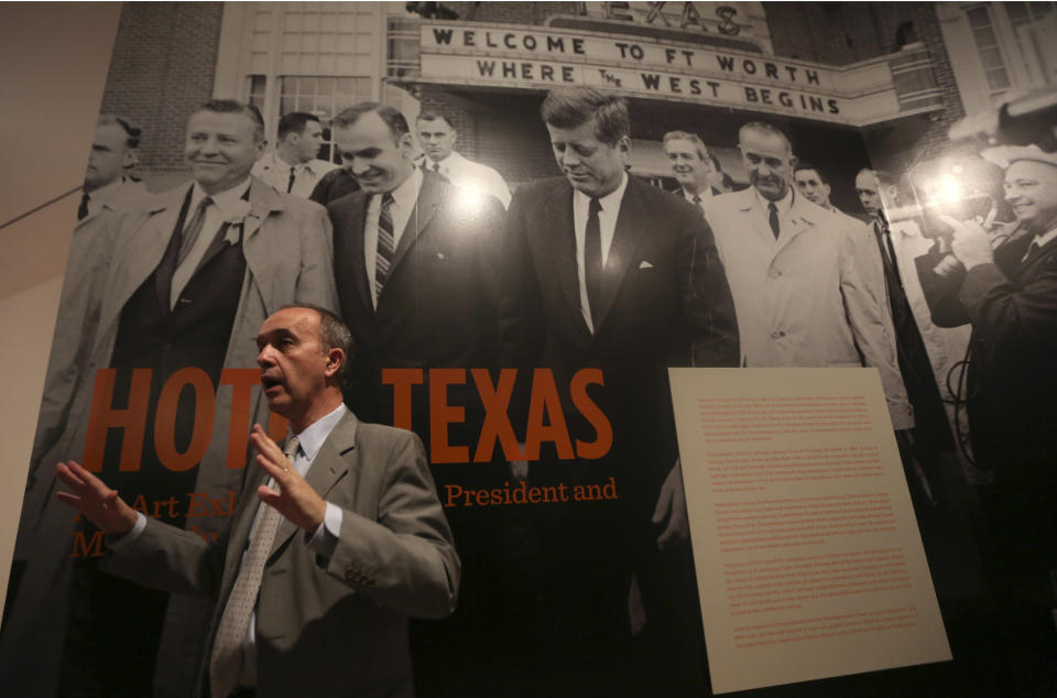 Curator Olivier Meslay speaks at the entrance of the exhibit "Hotel Texas: An Art Exhibition for the President and Mrs. John F. Kennedy," during a press preview at the Dallas Museum of Art Wednesday, May 22, 2013, in Dallas. The exhibit reunites 14 of the 16 works that were placed in Suite 850 for the Kennedys' one-night stay in Fort Worth and includes photos of the suite before and after the artwork was placed there, video footage of the room being prepared for the Kennedys and historical artifacts from the visit, including a sign welcoming the Kennedys to Texas. (AP Photo/LM Otero)