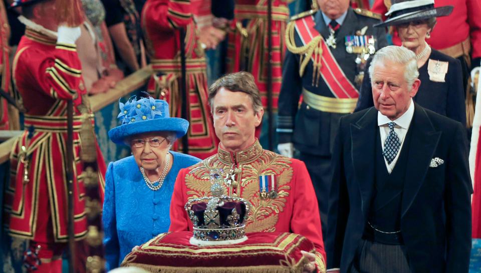 Queen Elizabeth II and Prince Charles, right, walk through the Royal Gallery during the State Opening of Parliament in London in 2017.