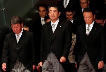 Japan's Prime Minister Shinzo Abe leads his cabinet ministers as they prepare for a photo session at Abe's official residence in Tokyo