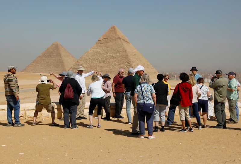 Tourists gather at the Great Pyramids of Giza, on the outskirts of Cairo
