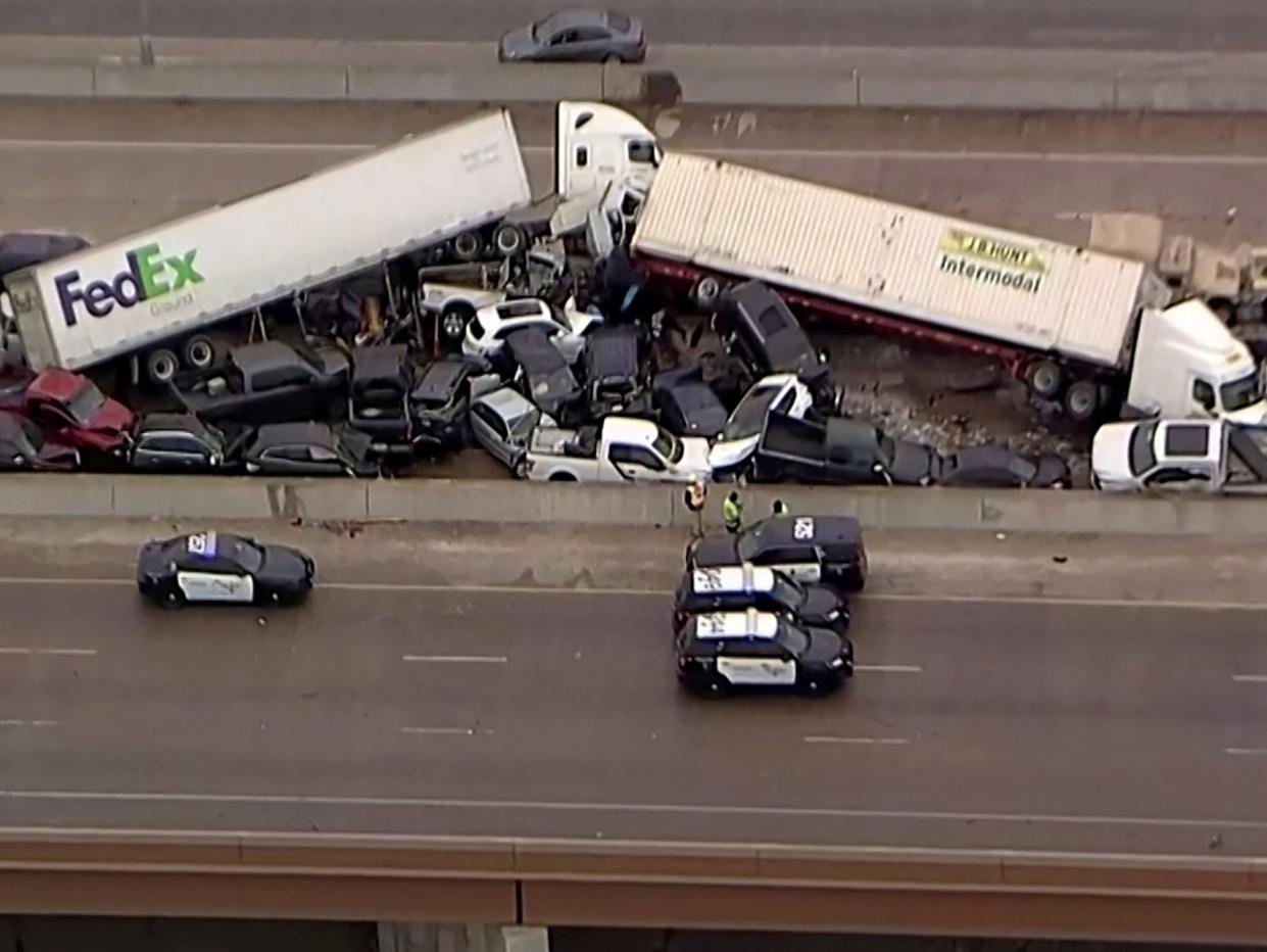 <p>Cars and trucks are wedged together after a deadly multi-vehicle pileup on the ice covered I-35 in a still image from video in Fort Worth, Texas, on 11 February 2021</p> ((Reuters))