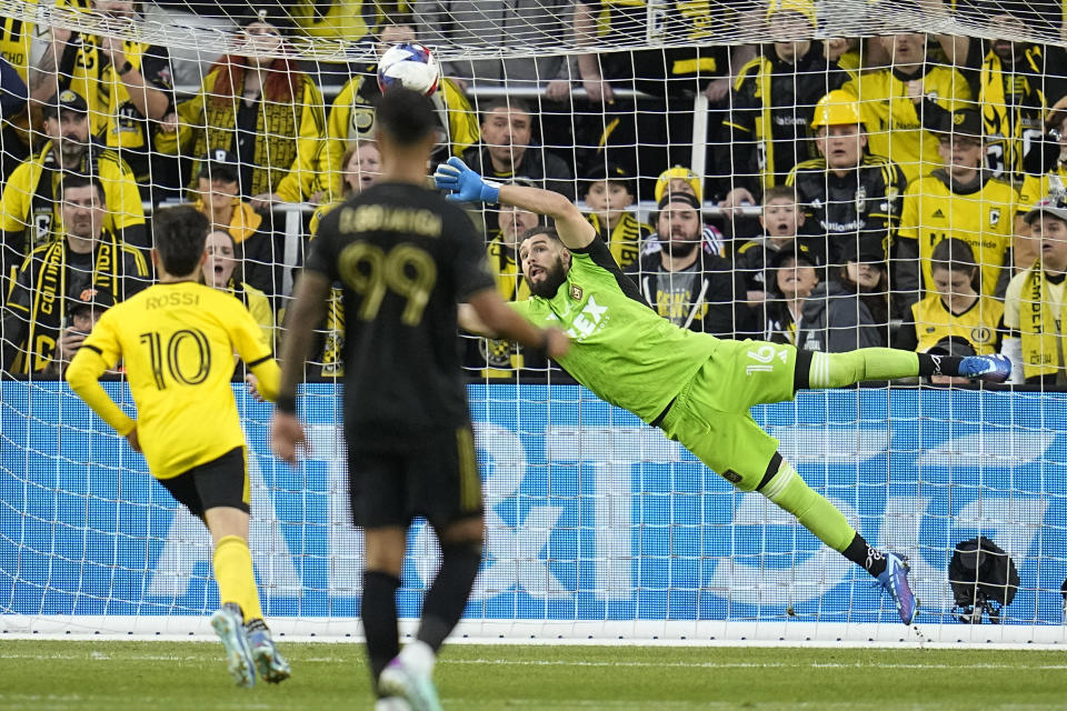 RETRANSMITTING TO CORRECT TEAM TO LOS ANGELES FC - Los Angeles FC goaltender Maxime Crepeau (16) blocks a shot in front of Columbus Crew forward Diego Rossi (10) and LA Galaxy's Denis Bouanga, center, in the first half MLS soccer championship match, Saturday, Dec. 9, 2023, in Columbus, Ohio. (AP Photo/Sue Ogrocki)