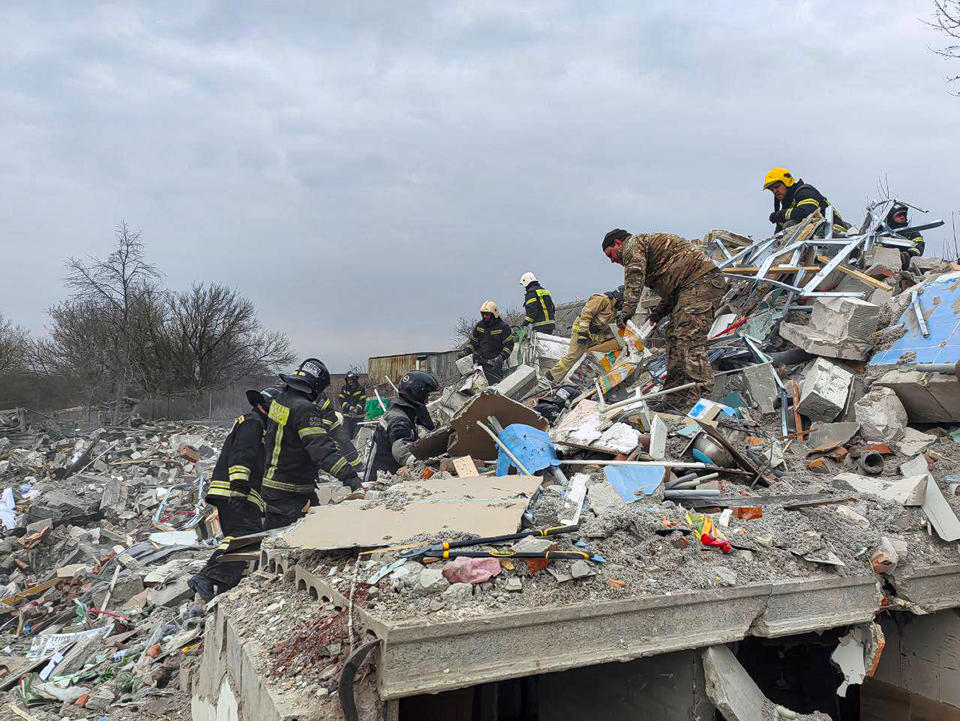 This photo released by Belgorod region governor Vyacheslav Gladkov's telegram channel on Monday, March 18, 2024, shows emergency ministry employees working at the destroyed building after shelling from the Ukrainian side, in Nikolskoye village, Belgorod region, Russia. Belgorod region governor Vyacheslav Gladkov says four people were killed in the shelling, not far from the border with Ukraine. (Belgorod Region Governor Vyacheslav Gladkov telegram channel via AP)