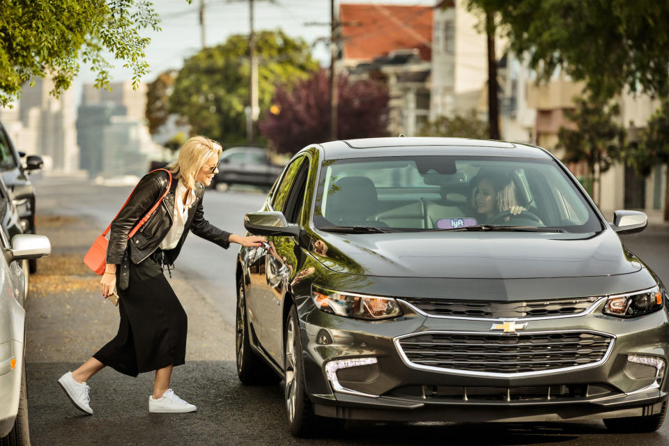 Woman getting into a car.