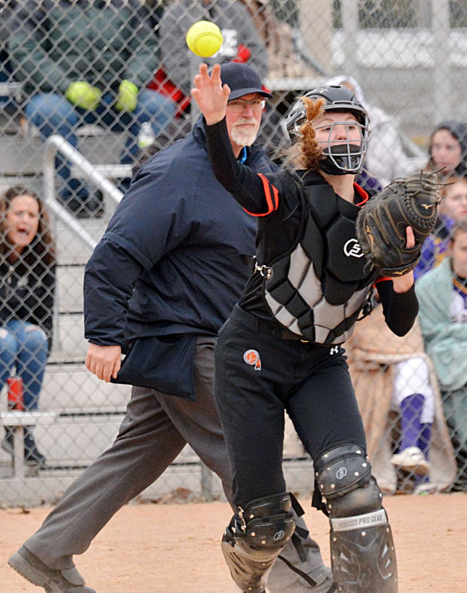Sioux Falls Washington catcher Isabel Carda throws to first for the final out of the game as umpire Travis Young looks on during a high school softball game on Tuesday, April 18, 2023 at Koch Complex.