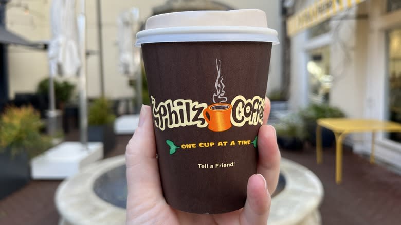 hand holding Philz Coffee cup