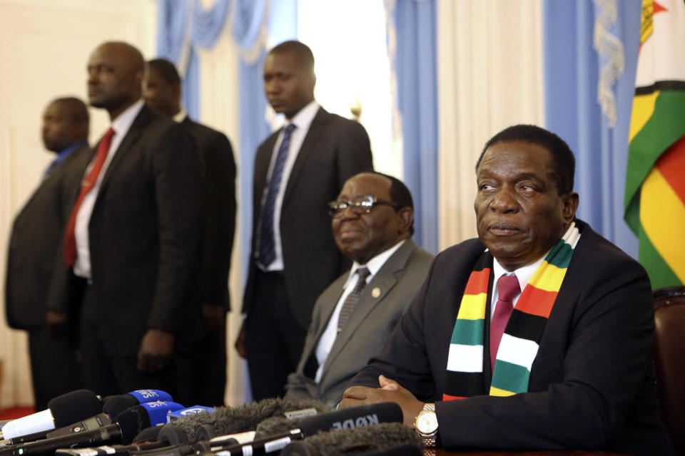 Zimbabwean President elect Emmerson Mnangagwa,right, addresses a press conference in Harare ,Friday, Aug, 3, 2018. Zimbabwe's president says people are free to approach the courts if they have issues with the results of Monday's election, which he carried with just over 50 percent of the vote. President Emmerson Mnangagwa spoke to journalists shortly after opposition leader Nelson Chamisa called the election results manipulated and said they would be challenged in court. (AP Photo/Tsvangirayi Mukwazhi)