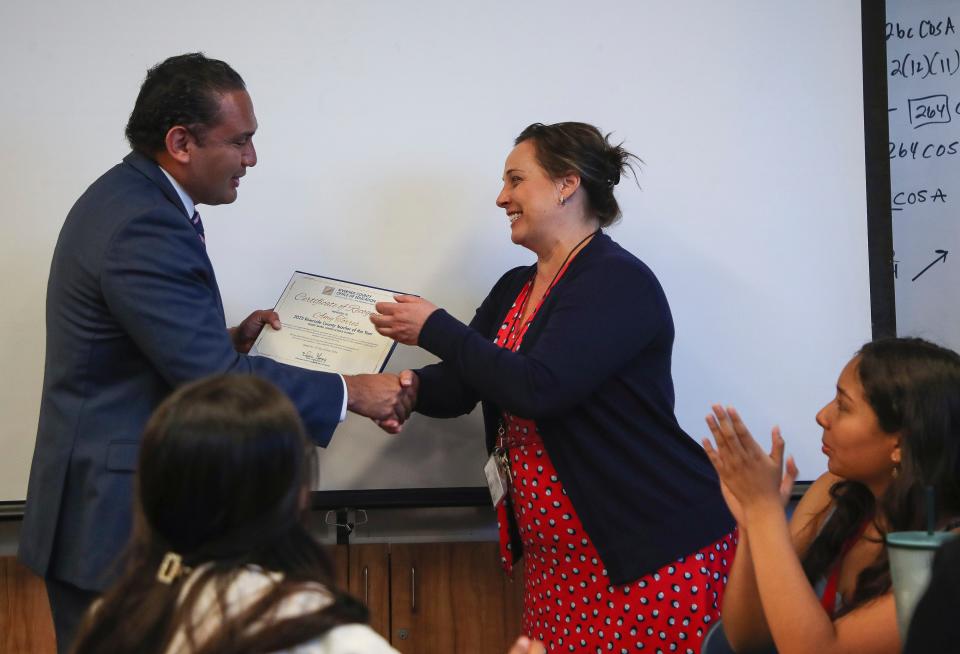 Indio High School teacher Amy Torres, right receives a Riverside County Teacher of the Year certificate from Dr. Edwin Gomez with the Riverside Office of Education at Indio High School in Indio, Calif., May 16, 2024.