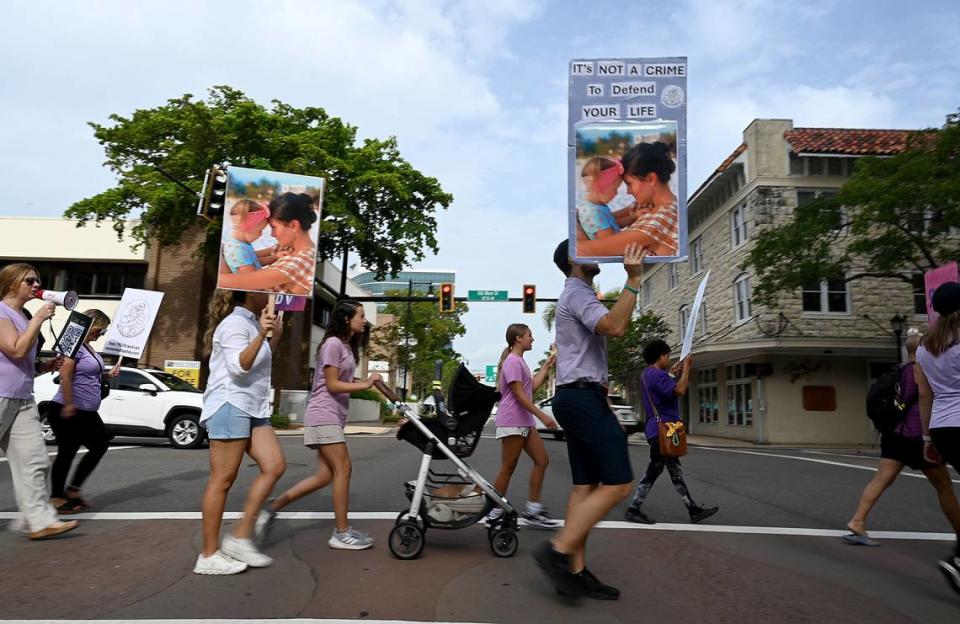 Supporters of Ashley Benefield march in downtown Bradenton ahead of her trial scheduled for July 22. Benefield is charged with second-degree murder for allegedly shooting her estranged husband in Sept. 2020.