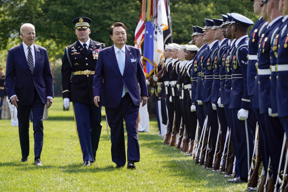 President Joe Biden and South Korea's President Yoon Suk Yeol review the troops with Col. David Rowland, commander of the 3rd U.S. Infantry Regiment, The Old Guard, during a State Arrival Ceremony on the South Lawn of the White House in Washington, Wednesday, April 26. 2023. (AP Photo/Evan Vucci)