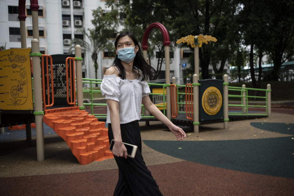 Lune Loh, 25, a transgender woman, walks through a playground, a common feature of public housing in Singapore, as she heads to lunch on Thursday, Aug. 18, 2022. Loh finds herself grappling with questions about her future: Like whether any company will ever employ her, or whether she will ever be able to have a biological child, all because her government refuses to see her for who she is. (AP Photo/Wong Maye-E)