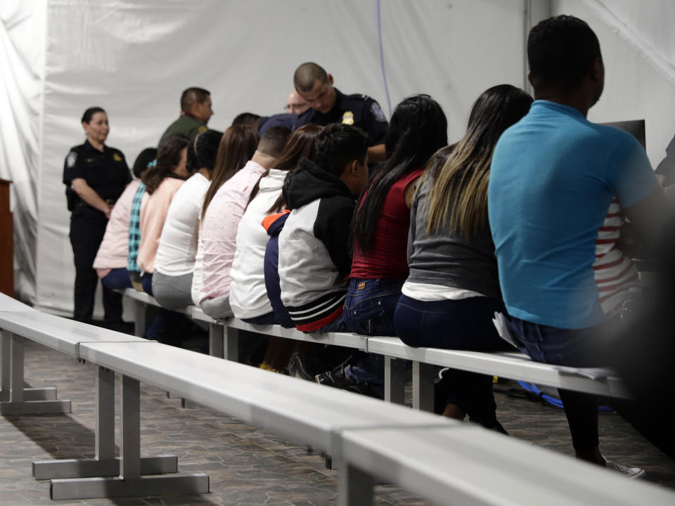 Migrants who are applying for asylum in the United States go through a processing area at a new tent courtroom at the Migration Protection Protocols Immigration Hearing Facility, Tuesday, Sept. 17, 2019, in Laredo, Texas. (AP Photo/Eric Gay)