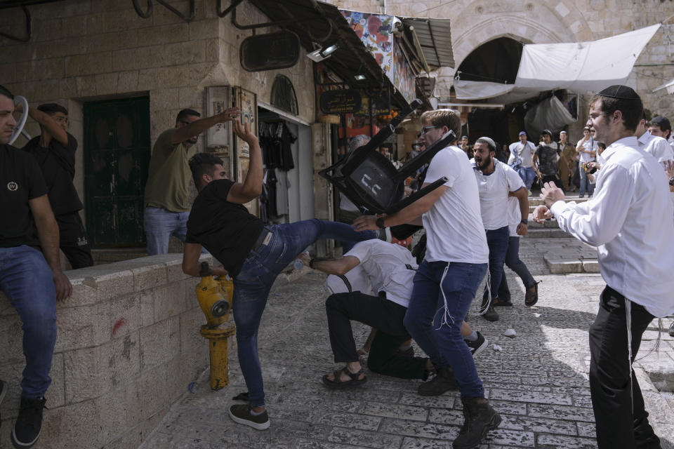 Palestinians and Jewish youths clash in Jerusalem's Old City as Israelis mark Jerusalem Day, an Israeli holiday celebrating the capture of the Old City during the 1967 Mideast war. Sunday, May 29, 2022. Israel claims all of Jerusalem as its capital. But Palestinians, who seek east Jerusalem as the capital of a future state, see the march as a provocation. Last year, the parade helped trigger an 11-day war between Israel and Gaza militants. (AP Photo/Ariel Schalit)