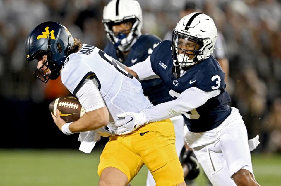 Penn State cornerback Johnny Dixon stops West Virginia’s Nicco Marchiol during the game on Saturday, Sept. 2, 2023.