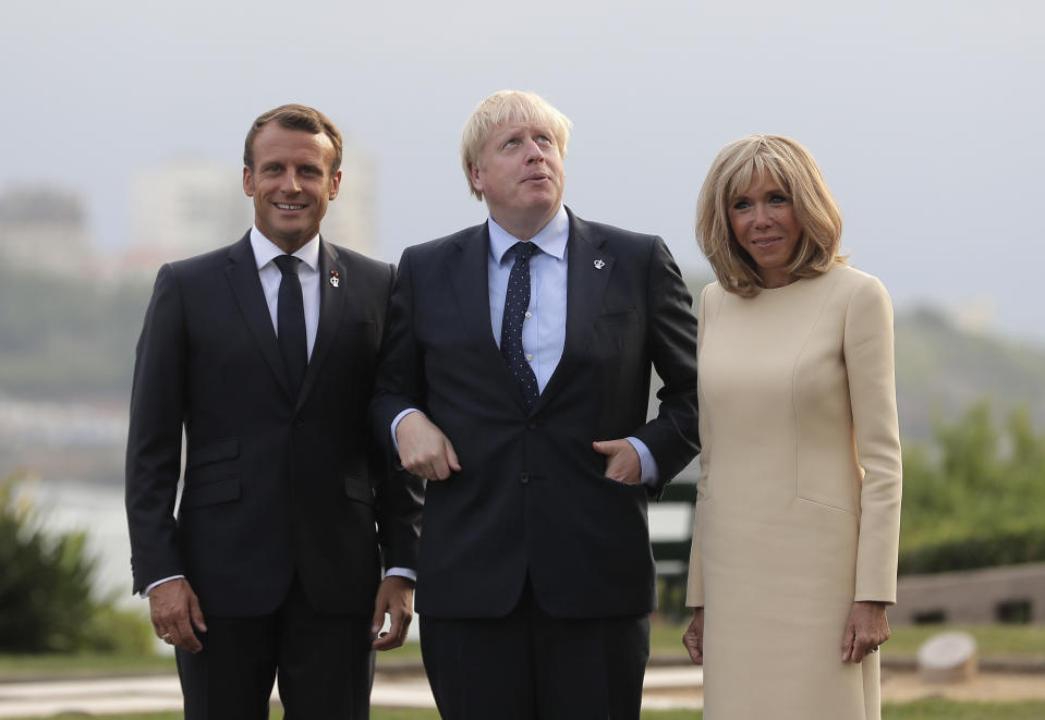French President Emmanuel Macron and his wife Brigitte welcome Britain's Prime Minister Boris Johnson at the Biarritz lighthouse, southwestern France, ahead of a working dinner Saturday, Aug.24, 2019. Shadowed by the threat of global recession, a U.S. trade war with China and the possibility of one against Europe, the posturing by leaders of the G-7 rich democracies began well before they stood together for a summit photo. (AP Photo/Markus Schreiber)