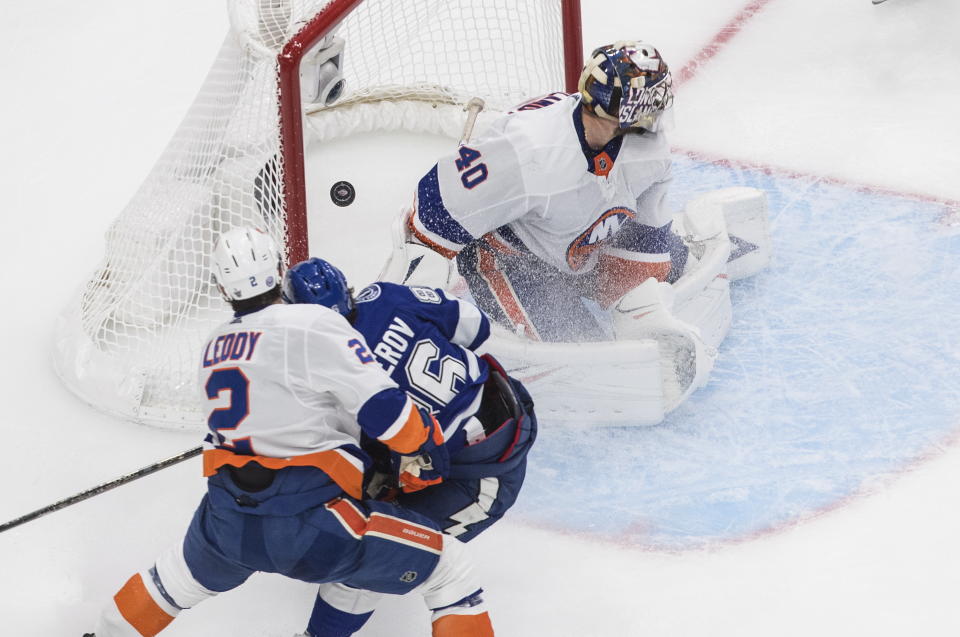 Tampa Bay Lightning's Nikita Kucherov (86) scores against New York Islanders goalie Semyon Varlamov (40) as Islanders' Nick Leddy (2) defends during third-period NHL Eastern Conference final playoff game action in Edmonton, Alberta, Monday, Sept. 7, 2020. (Jason Franson/The Canadian Press via AP)