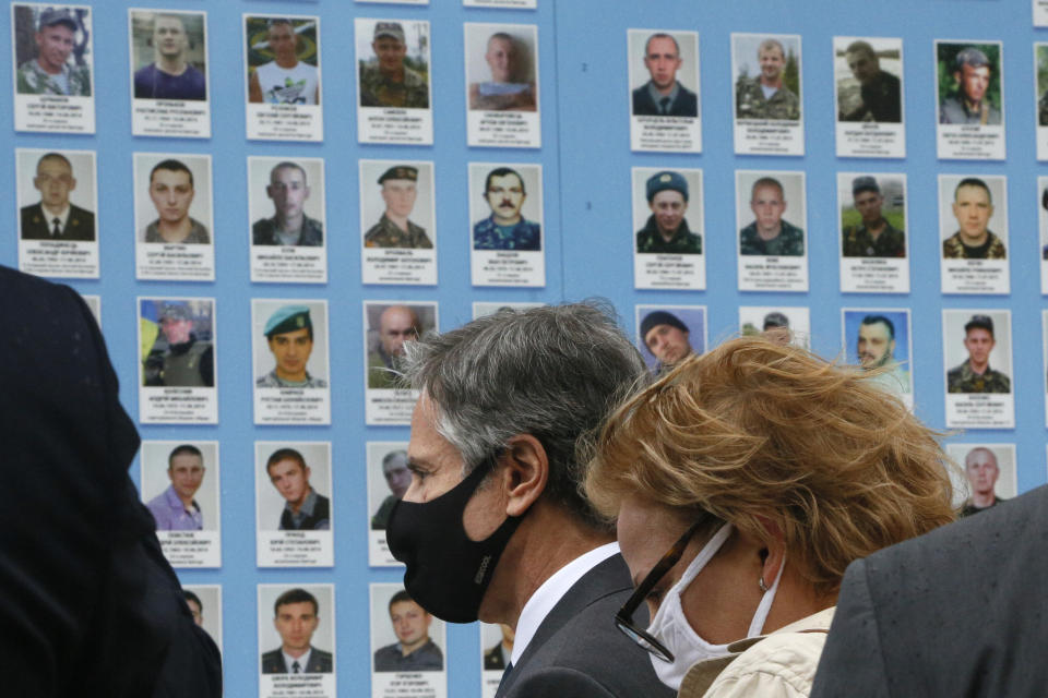 U.S. Secretary of State Antony Blinken pays respect the Memorial Wall of Fallen Defenders of Ukraine in Russian-Ukrainian War in Kyiv, Ukraine, Thursday, May 6, 2021. (AP Photo/Efrem Lukatsky, Pool)