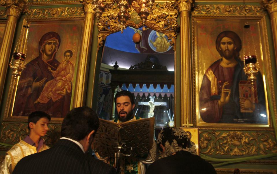 A Christian Orthodox worshipper attends Mass at St. Porphyrius Church in Gaza City, Sunday, April 8, 2012.