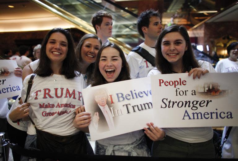 Supporters of Donald Trump are seen as he announces his bid for the presidency during an event at the Trump Tower in New York City on June 16, 2015