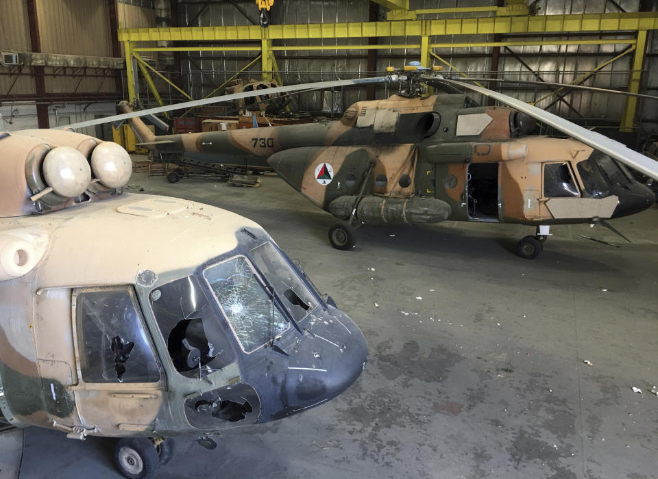 FILE - Damaged Afghan military helicopters are parked inside the Hamid Karzai International Airport after the Taliban's takeover, in Kabul, Afghanistan, Sept. 5, 2021. A year-old report by Washington’s Afghanistan watchdog warned in early 2021, months before President Joe Biden announced the end to America’s longest war, the Afghan air force would collapse without critical U.S. aid, training and American maintenance. The report by the Special Inspector General for Afghanistan Reconstruction John Sopko was classified back when it was written and only declassified on Tuesday, Jan. 18, 2021. (AP Photo/Mohammad Asif Khan, File)