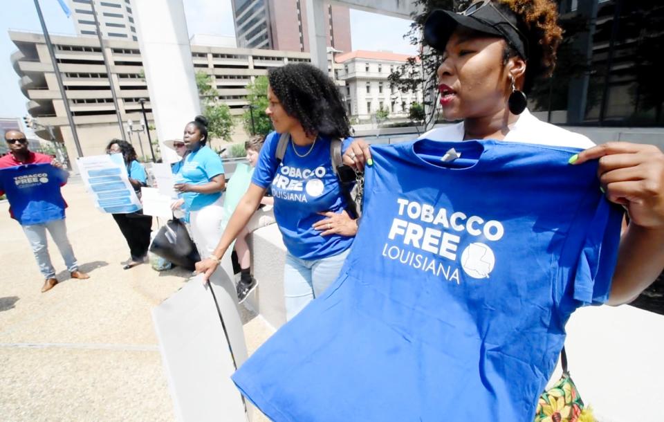 Cherie Gray chants "be smoke free, keep your promise" outside Government Plaza moments before the Shreveport City Council meeting on May, 23, 2023.