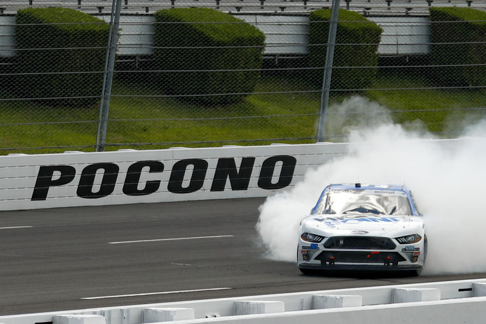 Chase Briscoe smokes his tires in celebration after winning a NASCAR Xfinity Series auto race at Pocono Raceway, Sunday, June 28, 2020, in Long Pond, Pa. (AP Photo/Matt Slocum)