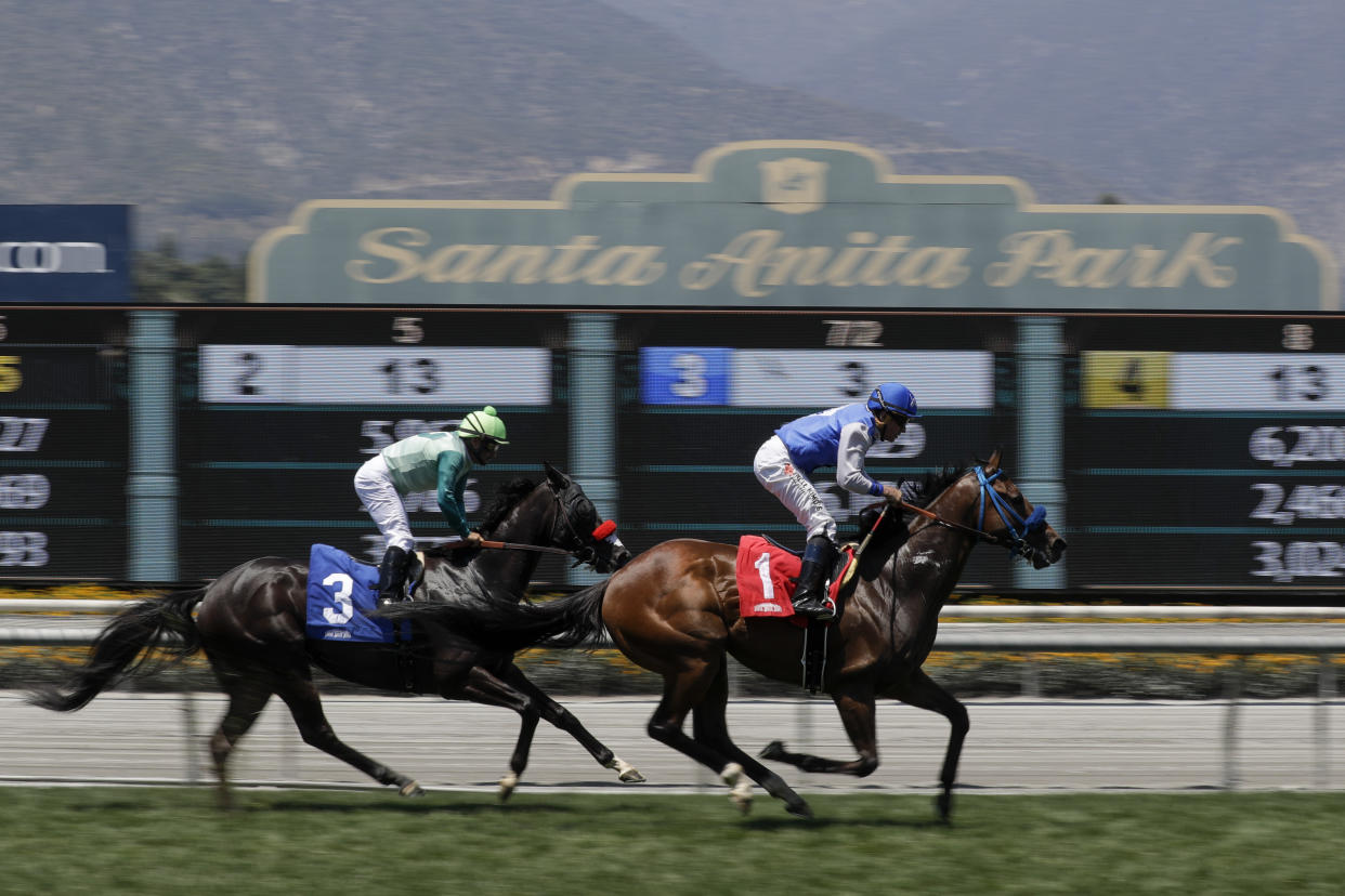 FILE - In this June 23, 2019 file photo Eddie Haskell, right, with jockey Kent Desormeaux aboard, win the third race during the last day of the winter/spring meet at the Santa Anita Park race track in Arcadia, Calif. Governor Gavin Newsom signed a law, Wednesday June 26,2019 that would give the California Horsing Racing Board the authority to immediately suspend the license of Santa Anita. Thirty horses have died at the track in recent months. (AP Photo/Chris Carlson, File)