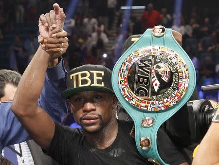 WBC/WBA welterweight champion Floyd Mayweather Jr. of the U.S. celebrates his victory over Marcos Maidana of Argentina at the MGM Grand Garden Arena in Las Vegas, Nevada September 13, 2014. REUTERS/Steve Marcus/Files