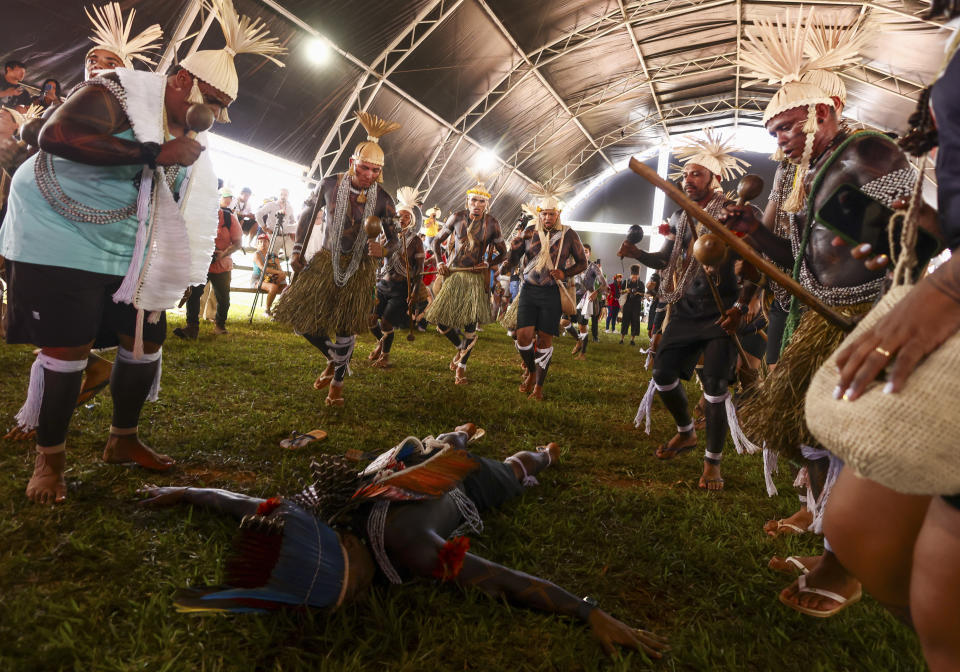 Indigenous people perform a ceremony during the 20th annual Free Land Indigenous Camp in Brasilia, Brazil, Monday, April 22, 2024. The 7-day event aims to show the unity of Brazil's Indigenous peoples in their fight for the demarcation of their lands and their rights. (AP Photo/Luis Nova)