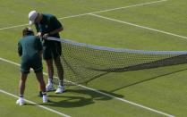 Groundstaff prepare net before the first day's play at the Wimbledon Tennis Championships in London, June 29, 2015. REUTERS/Stefan Wermuth