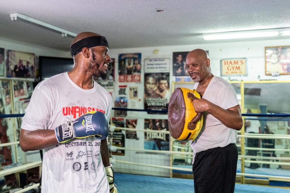 Tony Harrison, left, trains with his father Ali Salaam, who died in 2020 from COVID-19 complications.