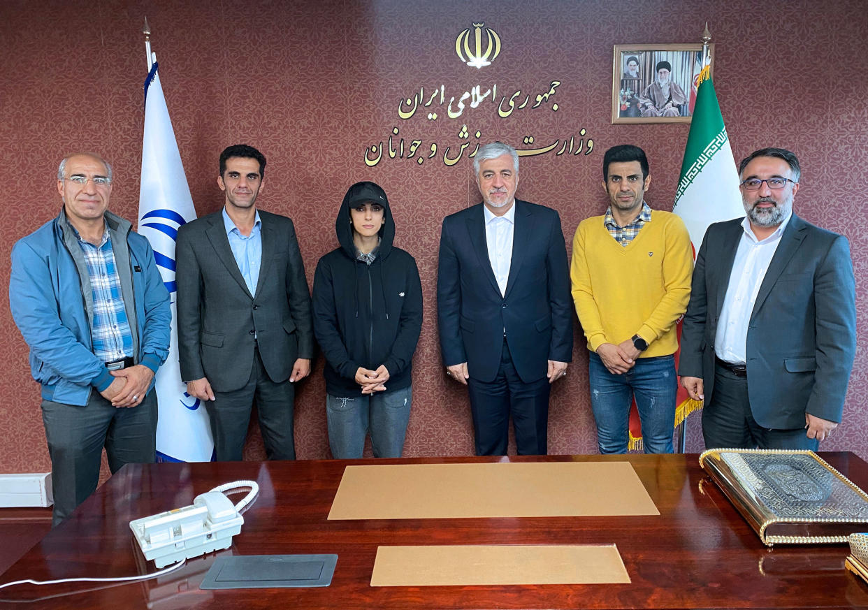 Iran’s Minister of Sport and Youth Hamid Sajjadi, center right, and climber Elnaz Rekabi, center left, pose for a photo, in Tehran, Iran, on Wednesday, Oct. 19, 2022.