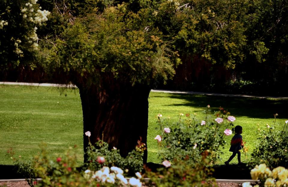 People enjoy the outdoors at Garfield Park near a house that sold for $2.5 million.