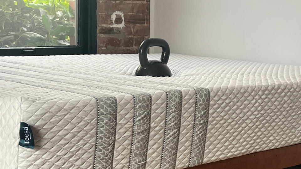 A kettlebell sinking into the Leesa Sapira Hybrid Mattress