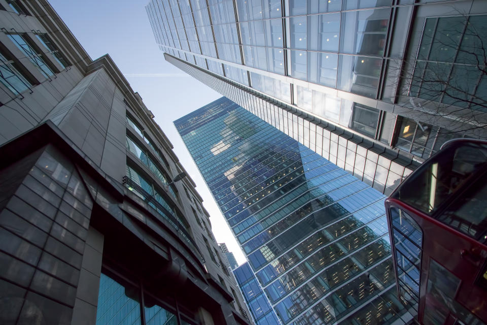 London city center skyscraper building. Business architecture UK. Tower blocks rising above central London bus.