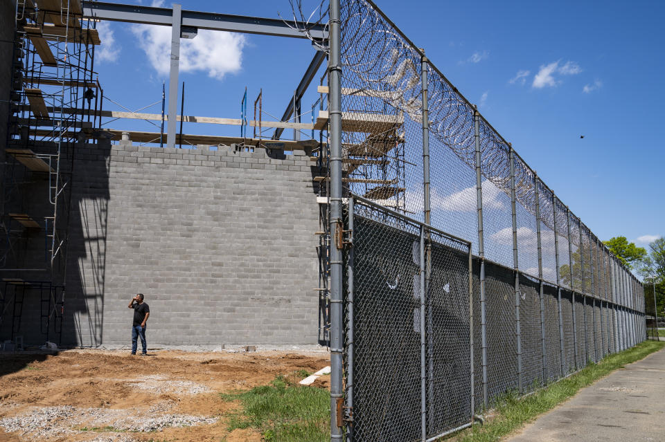 Jimmy Pilinci, studio and grounds manager, stands beside a soundstage under construction at the former Arthur Kill Correctional Facility, Tuesday, May 11, 2021, in the Staten Island borough of New York. The facility was purchased by Broadway Stages in 2017 and has been transformed into a film and television studio. Much of the prison was preserved as a set, lending authenticity to scenes in productions. Five other sound stages are being built on the 69-acre site, giving production companies the ability to shoot entire projects. (AP Photo/John Minchillo)