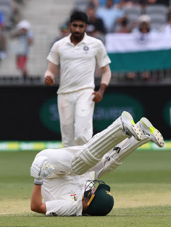 Australia's Marcus Harris falls after being struck by a delivery from India's Jasprit Bumrah on day three of the second test match between Australia and India at Perth Stadium in Perth, Australia, December 16, 2018. AAP/Dave Hunt/via REUTERS