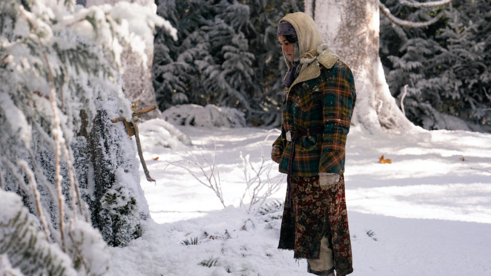 Lottie standing in the snow in front of weird tree in Yellowjackets