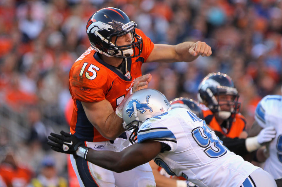 Quarterback Tim Tebow of the Denver Broncos is hit by Cliff Avril of the Detroit Lions at Invesco Field at Mile High on October 30, 2011 in Denver, Colorado. The Lions defeated the Broncos 45-10, and afterward they used such terms as "embarrassing" and "joke" to describe Tebow's performance. (Photo by Doug Pensinger/Getty Images)